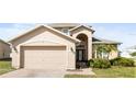 Inviting home featuring an attached two-car garage and nicely landscaped front yard at 4301 Presidio Way, Kissimmee, FL 34746