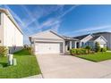 Charming single-Gathering home features a well-manicured lawn, inviting facade, and an attached two-car garage at 4479 Blue Rock Dr, Sanford, FL 32771
