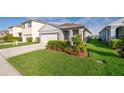 Well-maintained single-Gathering home with a manicured lawn, complemented by an attached two-car garage and landscaping at 4479 Blue Rock Dr, Sanford, FL 32771