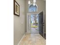 Bright foyer with tile flooring and a view of the front yard through a window at 4614 Falcon Ave, Kissimmee, FL 34746