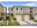 Inviting townhome showcasing a well-kept lawn and an attached one-car garage at 486 Lake Shore Pkwy, Davenport, FL 33896