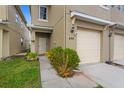 Attractive townhome featuring a cozy front entrance with a well-manicured garden at 486 Lake Shore Pkwy, Davenport, FL 33896