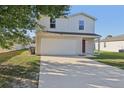 Charming two-story home with a spacious driveway and attached two-car garage at 49 Inconnu Dr, Poinciana, FL 34759
