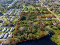 Aerial view of the property's lot lines, lake access, and bordering community at 495 Orange Ave, St Cloud, FL 34769