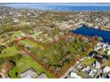 Aerial view of the property highlighting the surrounding area, water features, and bordering the shoreline at 495 Orange Ave, St Cloud, FL 34769