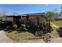 Cozy single-story home showcasing a side view with ample vegetation and manicured lawn at 502 Polaris Loop # 110, Casselberry, FL 32707