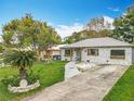 A charming home with an inviting driveway and a well-manicured lawn at 521 Florida Ave, St Cloud, FL 34769