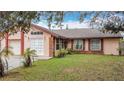 Attractive single-Gathering home boasts well-maintained landscaping and a welcoming entrance at 707 Divot Ln, Poinciana, FL 34759