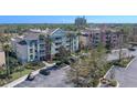 Exterior of the buildings, featuring beautiful landscaping, ample parking, and palm trees at 7602 Cabana Ct # 101, Reunion, FL 34747