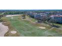 Aerial view of the lush green golf course, showing sand traps and walking path at 7602 Cabana Ct # 101, Reunion, FL 34747