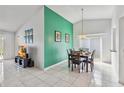 Cozy dining area features a vibrant accent wall, tile flooring, and sliding glass doors at 7706 Water Oak Ct, Kissimmee, FL 34747