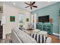 Bright living room featuring modern decor, a comfortable sofa, and ample natural light at 8029 Sandy Toes Way, Kissimmee, FL 34747