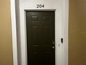 Classic front door with secure entry, enhancing the welcoming feel of this condo unit at 8103 Coconut Palm Way # 204, Kissimmee, FL 34747