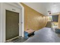 Condo hallway with door to unit 204, bench seating, and stairs at 8103 Coconut Palm Way # 204, Kissimmee, FL 34747