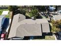 An aerial view of a house with a gray roof and a chimney and well-kept surrounding property at 8568 Park Highland Dr, Orlando, FL 32818