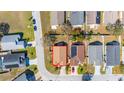 Aerial view of the home showcasing its location in a residential neighborhood, with solar panels at 919 Lake Charles Dr, Davenport, FL 33837