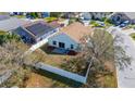 Aerial view of the home's fenced backyard featuring a well-maintained lawn and mature trees at 919 Lake Charles Dr, Davenport, FL 33837