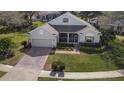 Aerial view of a well-maintained home, showcasing the brick driveway and manicured front lawn at 993 Everest, Clermont, FL 34711