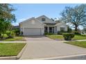 Inviting one-story home with a brick driveway, manicured lawn, and lovely front yard landscaping at 993 Everest, Clermont, FL 34711