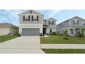Charming two-story home with a well-maintained lawn and a two-car garage at 1143 Seedorf Dr, Winter Haven, FL 33881