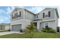 Beautiful home featuring a well-manicured lawn and a two-car garage at 1143 Seedorf Dr, Winter Haven, FL 33881