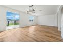 Bright, open living room featuring hardwood floors and sliding glass doors to the backyard at 1143 Seedorf Dr, Winter Haven, FL 33881