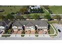An aerial view of the townhomes featuring brick-paved driveways and community landscaping nestled in a well-maintained neighborhood at 1737 Kato Way, Kissimmee, FL 34744