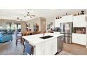 Bright, open kitchen featuring a central island, stainless steel dishwasher, and breakfast bar at 17418 Blazing Star Cir, Clermont, FL 34714