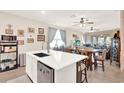 Bright, open kitchen featuring a central island, stainless steel dishwasher, and breakfast bar at 17418 Blazing Star Cir, Clermont, FL 34714
