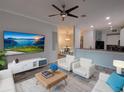 Cozy living room featuring modern décor, sleek furnishings, and an open floor plan at 204 New Providence # 10104, Davenport, FL 33897