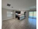 Spacious open kitchen with stainless steel appliances, island, and views of the pool at 220 Brookes Pl, Haines City, FL 33844