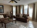 Cozy living room with two couches, decorative pillows, marble coffee table, and plenty of natural light at 2494 Sweetwater Club Cir # 55, Kissimmee, FL 34746