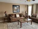 Comfortable living room with plush sofas, stylish decor, neutral colors, and great natural light at 2494 Sweetwater Club Cir # 55, Kissimmee, FL 34746