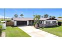 Attractive home showcases a manicured lawn, mature landscaping, and an attached two-car garage at 2512 Virginia Dr, Kissimmee, FL 34741