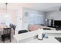 Open-concept view of dining room and living area with cohesive decor and abundant natural light at 2663 Sand Hill Point Cir, Davenport, FL 33837