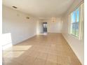 Bright living room featuring tile floors, ample natural light, and neutral walls for versatile decorating at 296 Sand Ridge Dr, Davenport, FL 33896