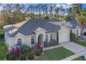 Beautiful single Gathering home with a well-manicured lawn, mature landscaping, and a two-car garage at 311 N Hampton Dr, Davenport, FL 33897