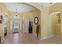 Bright foyer featuring tile flooring, a decorative light fixture, and a view into other rooms at 311 N Hampton Dr, Davenport, FL 33897