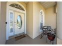 Inviting front porch with a cozy seating area, charming decor, and a welcoming front door at 3303 Ann Arbor Ct, St Cloud, FL 34772