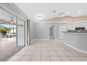 Bright living space with tile flooring, a vaulted ceiling, and sliding glass doors to the pool area at 3303 Ann Arbor Ct, St Cloud, FL 34772