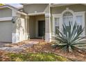 Close up of the front entrance, showcasing the covered porch and beautiful desert landscaping at 366 Highgate Park Blvd, Davenport, FL 33897