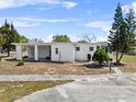 A charming single-story home featuring a covered front porch and mature landscaping at 425 S 12Th St, Lake Wales, FL 33853