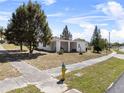 A lovely home with neat landscaping and a blue and yellow fire hydrant in the yard at 425 S 12Th St, Lake Wales, FL 33853