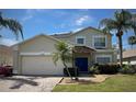 Inviting home exterior showcasing a two-car garage, palm trees, and a stone-accented entrance at 4602 Cumbrian Lakes Dr, Kissimmee, FL 34746
