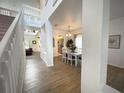 Bright and airy foyer showcasing hardwood floors and an open floor plan to the dining room and living room at 4602 Cumbrian Lakes Dr, Kissimmee, FL 34746