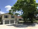 Charming two-story home with a well-manicured lawn, lush landscaping, and a two-car garage at 539 Libby Rd, Babson Park, FL 33827