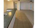 Bright, open-concept living area with tile flooring and glass doors leading to outdoor space and a modern ceiling fan at 5968 Westgate Dr # 101, Orlando, FL 32835