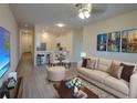Neutral living room with hardwood floors, stylish furniture, adjacent to dining area and kitchen at 709 Lucaya Loop # 1203, Davenport, FL 33897