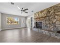 Inviting living room with a stone fireplace, wood-look floors, and plenty of natural light at 722 S 1St St, Lake Wales, FL 33853