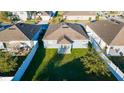 Aerial view of backyard with green grass and privacy fence at 751 Jefferson St, Davenport, FL 33837